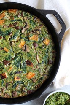 a pan filled with spinach and other food