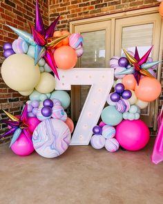 balloons and streamers are arranged around the letter z