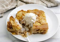 a piece of pie on a plate with ice cream