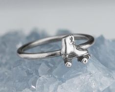 a close up of a silver ring with a skateboard on it's side