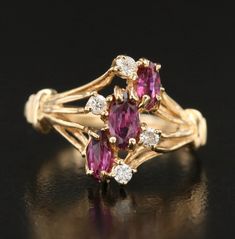 Indulge in the timeless beauty of this vintage ruby and diamond cluster ring, a captivating piece that exudes both elegance and sophistication. At its heart are vibrant marquise-cut rubies, their rich red hues creating a striking focal point that is enhanced by a shimmering halo of brilliant diamonds. The intricate 14K gold setting showcases the gemstones with an artful design, adding a layer of depth and charm to this exceptional ring. Weighing 2.40g, this ring is both lightweight and luxurious, making it perfect for special occasions or as an everyday statement piece. Although unmarked, the craftsmanship speaks volumes, offering a timeless accessory that radiates vintage allure. Currently sized at 5.5, this ring can be resized to your desired fit. Resizing is available for an additional Ruby Diamond Ring, Ruby Diamond Rings, Ruby Diamond, Timeless Accessories, Diamond Cluster Ring, Marquise Cut, Diamond Cluster, Brilliant Diamond, Gold Set