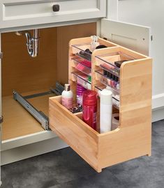 an open drawer in a kitchen filled with beauty products