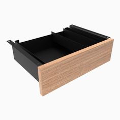 an open drawer with two compartments on the bottom and one in the middle, against a white background