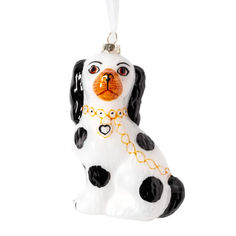 a glass ornament with a dog on it's face and black spots