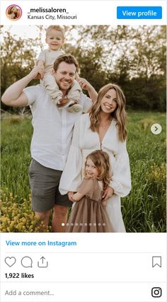 a man and woman holding a baby in their arms