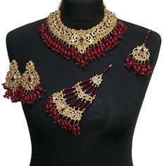 bridal jewellery set. Set includes- Necklace Earrings  Jhumar  Tikka Ruby Chandbali Jewelry Set With Stonework, Ruby Chandbali Jewelry Sets With Stone Work, Chandbali Ruby Jewelry Sets With Stone Work, Bollywood Ruby Jewelry Sets With Stone Work, Red Bollywood Jewelry Sets With Latkans, Traditional Red Jewelry Sets For Wedding, Red Chandbali Temple Bridal Sets, Red Bollywood Bridal Necklace With Latkans, Red Temple Jewelry Sets For Wedding