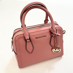 Beautiful $300 Michael Kors Ayden Dome Medium Satchel Bag. (38h9cyvs2l) Saffiano Leather Zip Closure Interior 1 Zip Pocket, 1 Slip Pocket Gold Hardware. Logo Hang Charm Removable And Adjustable Strap. Crossbody Capabilities Approx. 10 W X 8 H X 5 D Inches; 4" Handle Drop; 17.5-21.5" Adjustable Strap Drop Weight Approx. 1.10 Lb New And Original. Impeccable Condition. Item Comes From A Smoke Free Home. Chic Michael Kors Satchel For On-the-go, Classic Pink Michael Kors Bag, Modern Pink Michael Kors Bag, Chic Pink Michael Kors Satchel, Hardware Logo, Drop Weight, Classy Casual Outfits, Classy Casual, Satchel Bag