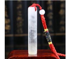 a piece of glass sitting on top of a wooden box next to a string and rope