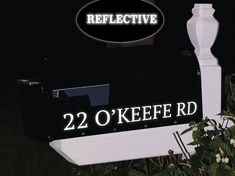 a black and white mailbox with the words 22 o'keefe rd on it