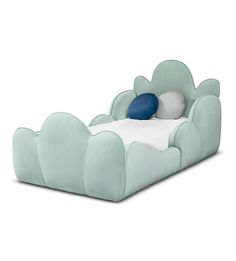 a bed that is shaped like a cloud with pillows on the top and bottom, sitting in front of a white background