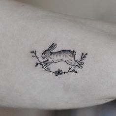 a small rabbit tattoo on the arm