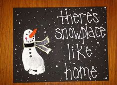 there's snowman like home painted on a black board with white writing and an orange nose