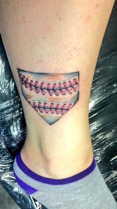 a baseball tattoo on the ankle