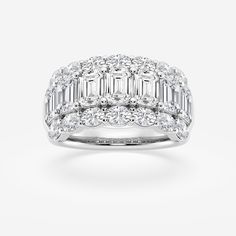 a white gold ring with baguetts and diamonds on top, set in 18k white gold