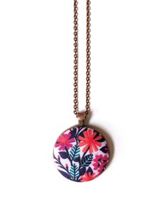 This handmade pink flowers pendant necklace is so beautiful! Such a bold and cheerful design in mood-boosting hues, it would make a lovely handmade gift! -The pendant is handmade with a fantastic, maximal pattern of bright magenta and coral colored flowers with aqua leaves on a light pink background. I designed the fabric myself and had it digitally printed so the necklace is truly unique. -18 inch oval link chain (45 cm) in an antique copper color with a lobster clasp -Pendant is 1.5 inch (38mm) -Chain and pendant setting are zinc alloy. The pendant is large, but still incredibly lightweight so it is easy to wear for a long time. -This makes a wonderful gift! For your best friend, mother, sister, that hard-to-shop-for teen, teachers, hair stylists ... or just a treat for yourself! It come Handmade Pink Pendant Flower Necklace, Pink Floral Print Jewelry As Gift, Pink Flower Charm Pendant Necklace, Pink Bohemian Necklace With Flower Charm, Floral Print Flower Necklaces For Gifts, Bohemian Pink Necklace With Flower Charm, Pink Bohemian Flower Pendant Necklace, Bohemian Pink Flower Pendant Necklace, Pastel Pink Flowers