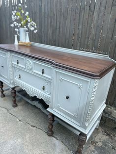 an old dresser with wood top and drawers