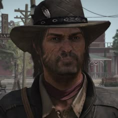 a man in a cowboy hat and leather jacket looking at the camera with an evil look on his face