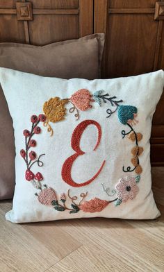 a decorative pillow with the number three embroidered on it