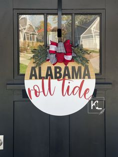 a door with a sign that says alabama roll tide and two red shoes hanging on it