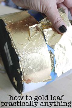 a person is painting gold leaf on a piece of tin foil with the words how to go leaf practically anything