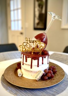 a birthday cake on a plate with grapes