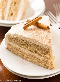 a piece of cake on a plate with cinnamon sticks sticking out of the top slice