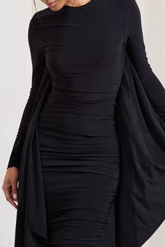 Taking occasion dressing from 0 to 100. our Keva maxi dress is the statement showpiece you've been looking for. Crafted in a premium. ultra-stretch. jersey and double lined for ultimate comfort and modesty. this LBD is a must. With ruching through the full body and long sleeves. this dress will flatter all body shapes. The dreamy cascading sleeve detailing is the perfect blend of elegance and high-fashion... need we say more?Features- High neckline- Bodycon fit- Long sleeves with cape detailing- Dress With Cape, Ruched Maxi Dress, Information Design, Cape Dress, High Neckline, Black Long Sleeve, Occasion Dresses, Jersey Fabric, Body Shapes