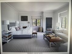 a large white bed sitting in the middle of a living room