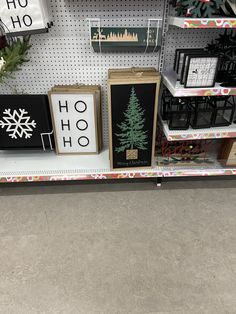 christmas decorations are displayed on the shelves in a store, with snowflakes and pine trees