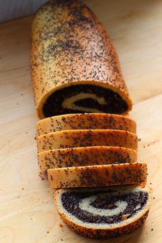 a sliced loaf of bread sitting on top of a wooden table