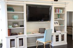 a living room filled with furniture and a flat screen tv