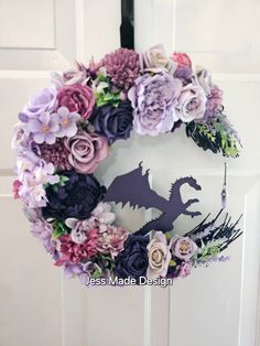 a wreath with flowers and a dragon on the front door is decorated with paper flowers