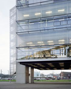 a tall building with glass balconies on top