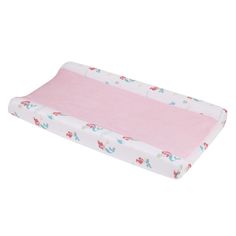 a baby crib mattress with pink sheets and flowers on the bottom, in front of a white background