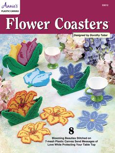 flower coasters in the shape of flowers on a table with pink and purple flowers