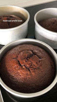 three pans filled with brownies sitting on top of a stove next to each other