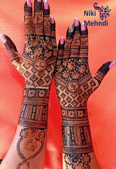 two hands with hendi designs on them