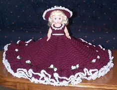 a crocheted doll sitting on top of a wooden table