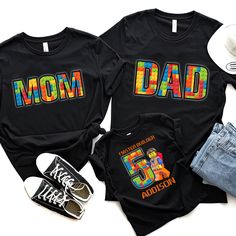 two shirts that say mom and dad with the number five on them next to some shoes