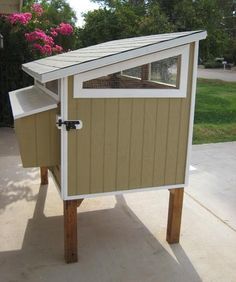 a small chicken coop in the middle of a driveway