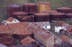 an aerial view of old buildings and silos