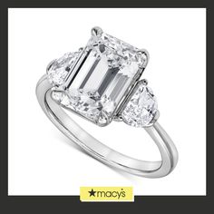 an emerald cut diamond ring with three pear shaped diamonds