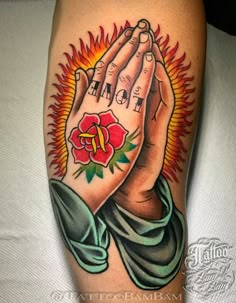 a tattoo with two hands holding a rose