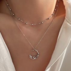 Discover the enchanting allure of our Dainty Gothic Moon Necklace. Featuring a striking silver half moon pendant, this layered necklace set offers a perfect blend of gothic charm and minimalist elegance. Crafted from high-quality sterling silver, it adds a touch of sophistication and mystique to any outfit. Ideal for layering or wearing alone, this versatile necklace makes a thoughtful and stylish gift for her, whether for a birthday, anniversary, or special occasion. Celebrate her unique style Metal Necklaces With Moon Phase, Moon Phase Choker Necklace, Silver Moon Charm Choker Necklace, Silver Layered Moon Charm Necklace For Gift, Silver Layered Necklace With Moon Charm As A Gift, Silver Layered Necklace With Moon Charm For Gift, Silver Choker Necklace With Moon Charm, Elegant Silver Half Moon Necklace, Elegant Layered Necklace With Moon Charm As Gift