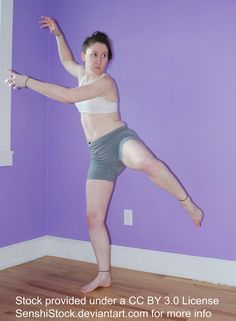 a woman standing on one leg in the air