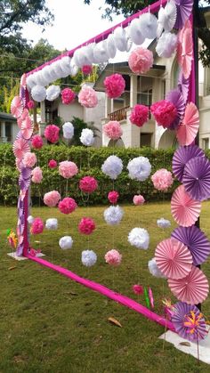 some pink and white decorations in the grass