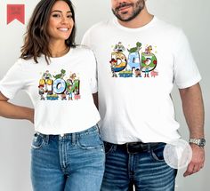 Super cute Mom or Dad Toy Story  tee shirt.    🔸This listing is for one item, please select each shirt you would like with their personalization separately  🔶 The design is a DTG  and printed on a Bella Canvas white unsex tee shirt. Please see second picture for measurements. Playful Father's Day T-shirt For Family, Casual Family T-shirt With Cartoon Print, Casual T-shirt With Cartoon Print For Family, Casual Cartoon Print T-shirt For Family, Playful Funny Print Family T-shirt, Family Cotton T-shirt With Cartoon Print, Family Cartoon Print Cotton T-shirt, Cotton T-shirt With Cartoon Print For Family, Cotton T-shirt With Character Print For Family