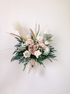 a bouquet of flowers is hanging on the wall