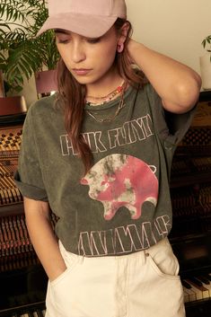 Distressed, mineral washed graphic t-shirt Vintage-style Pink Floyd Animals album cover graphic. Torn and distressed detailing at neckline, cuffs, hem. Round neckline. Short sleeves. Drop shoulder. Sleeves cuffed for styling only. Solid back. Loose, oversized fit. 100% Cotton. Imported top designed and printed in LA. Officially licensed Pink Floyd merchandise. Not eligible for discounts. Model wears size S. Distressed Graphic Tee, Style Pink, Pink Floyd, Oversized Fits, Drop Shoulder, Album Covers, Round Neckline, Vintage Style, Graphic T Shirt