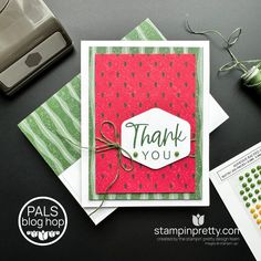 a thank you card with watermelon paper and some crafting supplies next to it